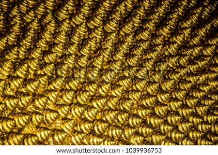 Closeup picture of the golden texture of the hair of the famous Reclining Buddha, Wat Pho, Bangkok, Thailand