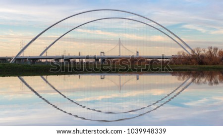 This is the picture of Reflection of Margaret Hunt Hill Bridge and Margaret McDermott Bridge during Day time from Trinity River, Dallas, Texas.