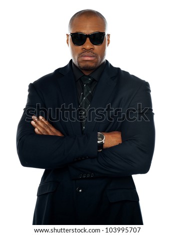 Serious african man in business suit. Posing with crossed arms