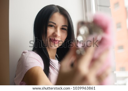 Glamour pregnant woman make selfie in window light