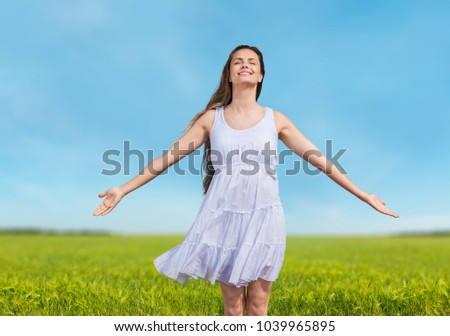 Happy Woman Enjoying Nature on meadow