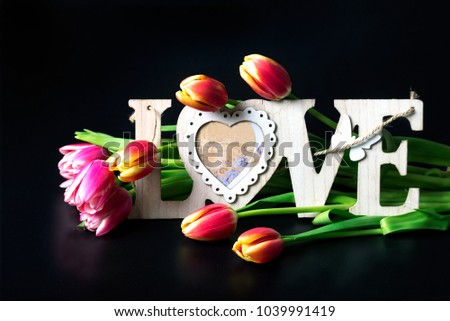 Flowers tulips with the inscription "Love"