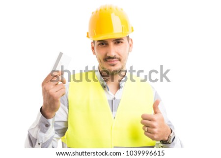 Architect or contractor holding debit credit card smiling and showing thumb up like gesture