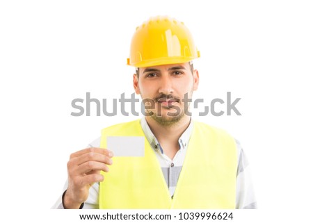 Friendly repairman or electrician holding and showing white empty business card with  blank copy text area space
