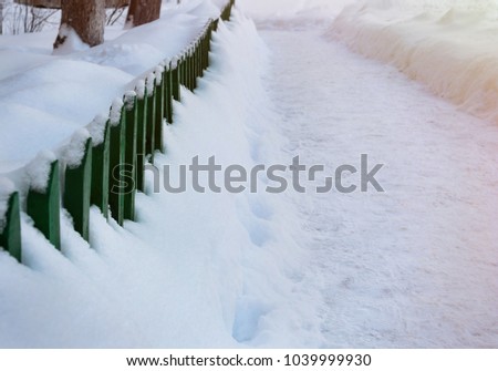 Road is covered by snow in winter outdoors.