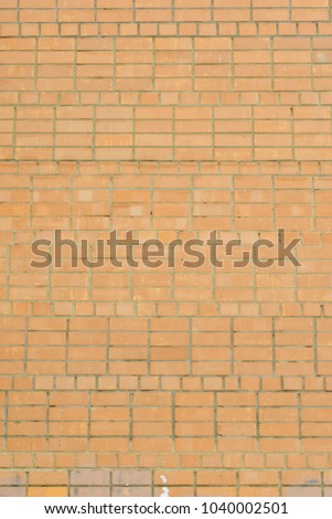 Beautiful blank background. Wall of light orange brick. Layout. The texture of the stone, even rows.