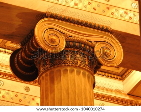 Extreme close up photo of detail in iconic ancient Greek style golden pillars of Academy of Athens, Attica, Greece