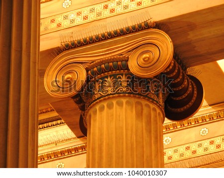 Extreme close up photo of detail in iconic ancient Greek style golden pillars of Academy of Athens, Attica, Greece