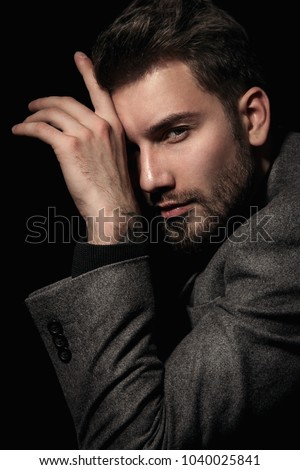 Handsome brutal man in gray suit cool hair style.Sexy Businessman. Confident, attractive, stylish. Fashion shooting. Actor. Royalty-Free Stock Photo #1040025841