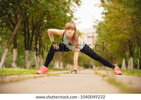 girl is engaged in sports exercises in nature