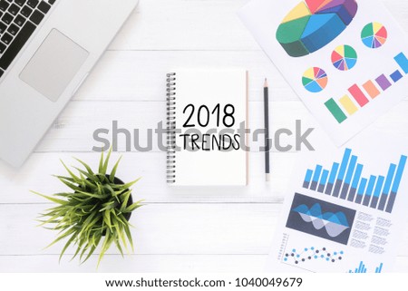 Minimal Work space - Flat lay view photo of working desk with a business trends of a new year notebook and laptop on white wooden background. Top View flat lay photography. New year 2018 concept