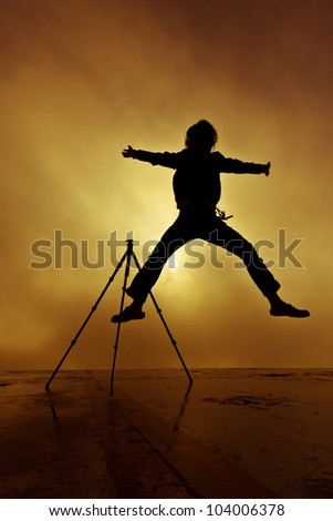Photographer silhouette shooting sunrise