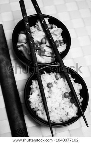 Chinese rice bowl on plastic background with chopsticks black and white photo photography