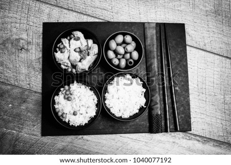 Chinese rice bowl on wood or wooden background with chopsticks black and white photo photography