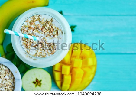 Overnight Oats with Mango and banana, apple on wooden table