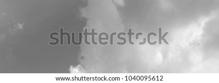 White clouds in the blue sky. Black and white image. Can be used as a header or banner on your website, blog or social media.