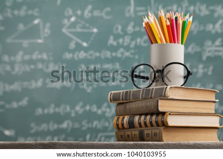 Chalkboard with stack book Royalty-Free Stock Photo #1040103955