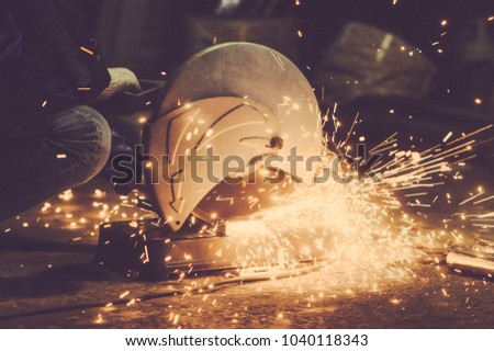 Worker cutting metal. Cutting metal angle grinder. Toned image. shearing metal parts metal sparks close. from the side view