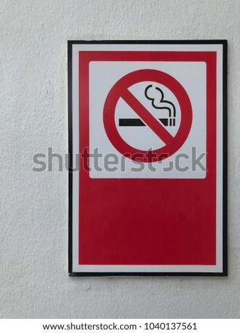 no smoking sign on the white wall.