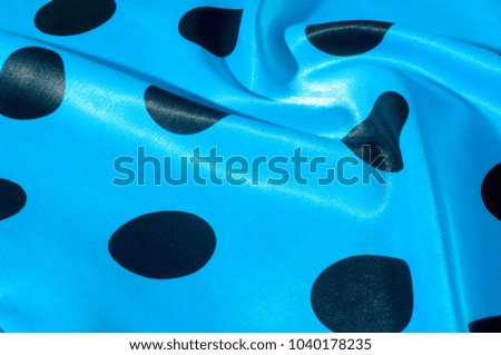 Texture, background, pattern. Silk fabric is blue and black polka. a magnificent point and decorative fabric made from natural fabric. This fabric can be used for projects such as design,