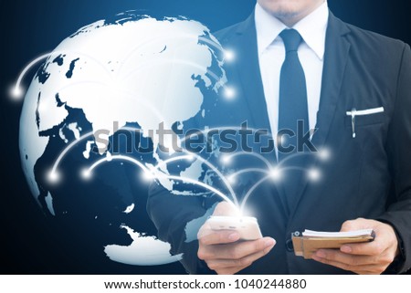Businessman touching global  network and mobile phone. communication and social media concepts.