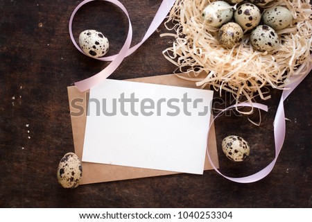 easter eggs, ribbons and nest on wood background mockup business card. invitation card with environment and details Mockup with postcard and easter eggs on dark