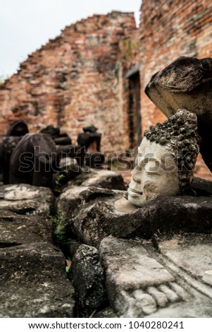 The head of the old Buddha and the ruins at Wat Phutthaisawan Ayutthaya An old temple.Hundreds of years.A beautiful and ancient temple.