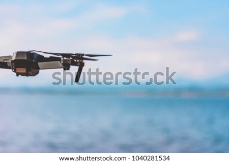 drone quad copter  with high resolution digital camera flying the sky with lake view