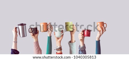 Many different arms raised up holding coffee cup Royalty-Free Stock Photo #1040305813