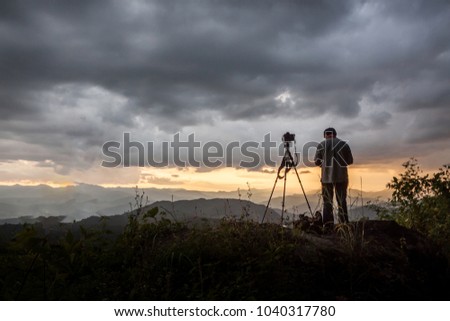 photographer take a photo on twilight in the Mountain of thailand