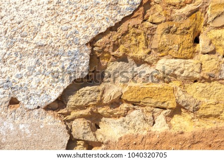 Old brown wall with stone masonry, background