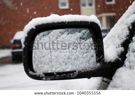 Frozen, with a snow covered front passenger car mirror |green | winter|snow
