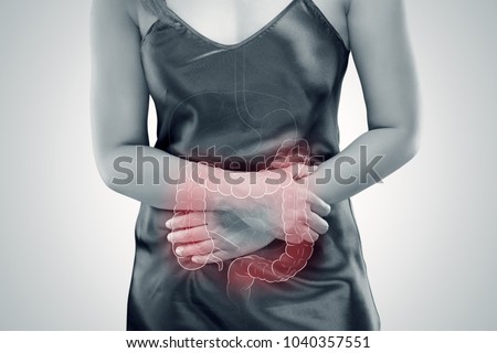 Ulcerative Colitis, The photo of large intestine is on the woman's body against gray background, Female anatomy, Concept with healthcare and medicine Royalty-Free Stock Photo #1040357551