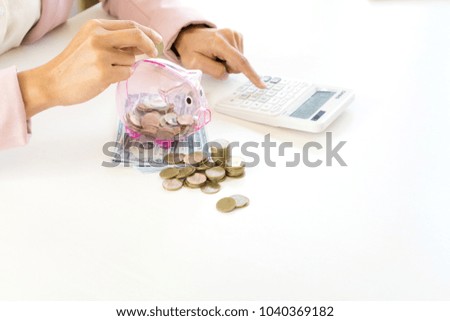 Business man woman hold collect coin in the row in front of the saving box concept economy investment