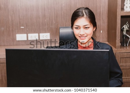 Businesswoman working with computer and typing text on keyboard at modern office