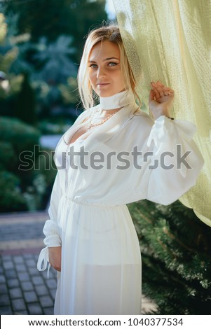 beautiful bride posing in a summer cafe