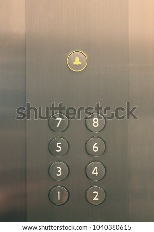 Elevator buttons on panel.