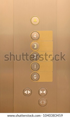 Elevator buttons on panel with blank label.
