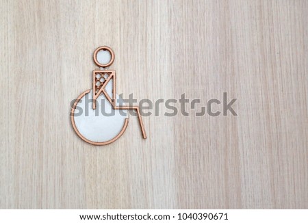 Disabled toilets icon on wood