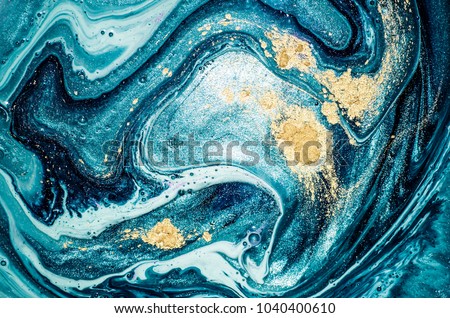 Abstract ocean- ART. Natural Luxury. Style incorporates the swirls of marble or the ripples of agate. Very beautiful blue paint with the addition of gold powder Royalty-Free Stock Photo #1040400610