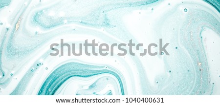 Abstract ocean- ART. Natural Luxury. Style incorporates the swirls of marble or the ripples of agate. Very beautiful blue paint with the addition of gold powder Royalty-Free Stock Photo #1040400631