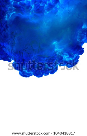 Color Liquid in dynamic flow forming interesting and unique shapes and bubbles. Colorful blue ink mixing in an unique pattern. Artistic design. Isolated on white background.