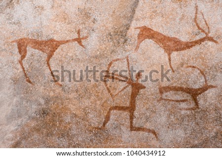 An image of an ancient man's hunting on the wall of a cave. ancient world history. Royalty-Free Stock Photo #1040434912