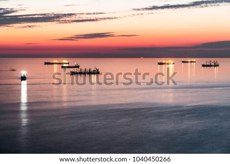 View of the Black Sea bay on a summer evening. Magnificent sunset and silhouettes of ships