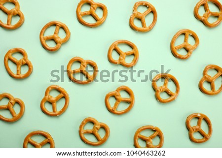 A beautiful salty biscuit on a minty background. Top view, copy space. 