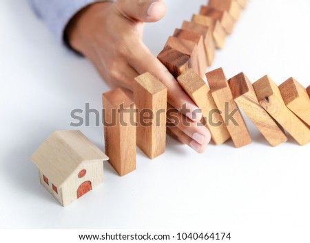 businessman hand protect home, insurance concept Royalty-Free Stock Photo #1040464174