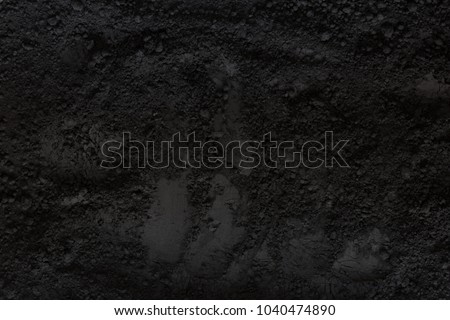 Activated charcoal powder background Royalty-Free Stock Photo #1040474890