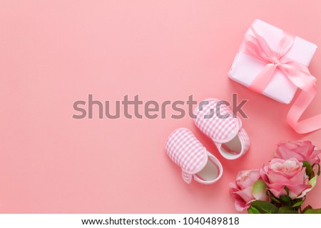 Top view aerial image of decoration Happy mothers day holiday background concept.Flat lay gift box with rose & baby shoe on modern beautiful pink paper at home office desk.Free space for design.