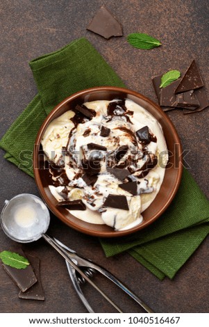 Vanilla ice cream with chocolate chips and hot chocolate sauce. Summer cold dessert.