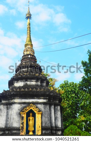 Antique pagoda in Chiang Mai and blue sky background. the picture have space in the right for text. the picture can use for invention card or decor in Buddhist living room.